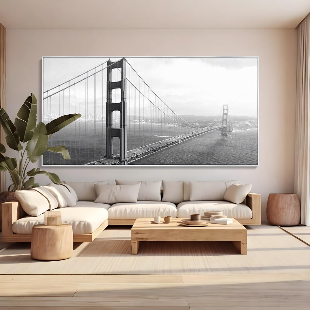 Tablou canvas cu fotografie alb-negru cu podul golden gate, in rama de aluminiu argintiu, pe perete intr-un living
